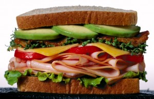 stacked sandwich with avocado topping